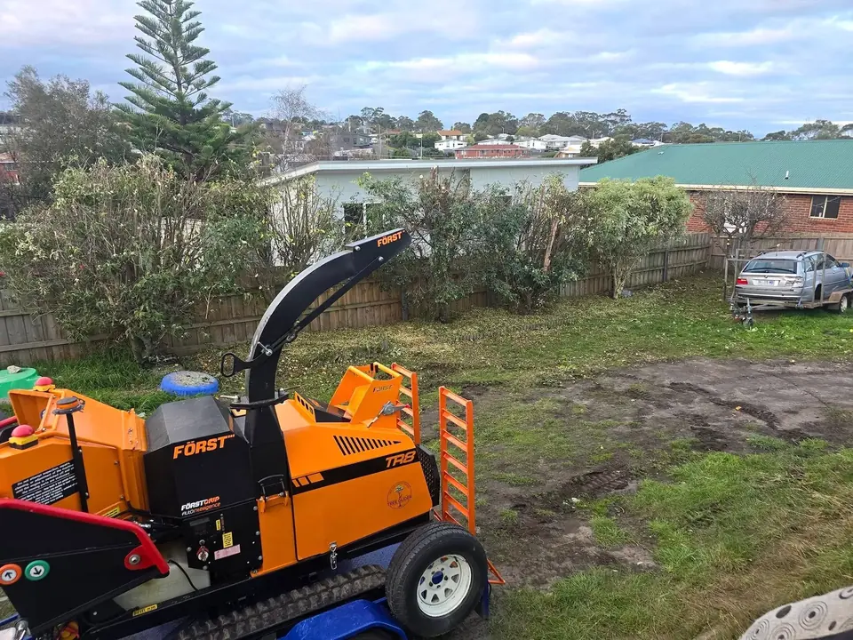 Wood chipper on a cleared outdoor property